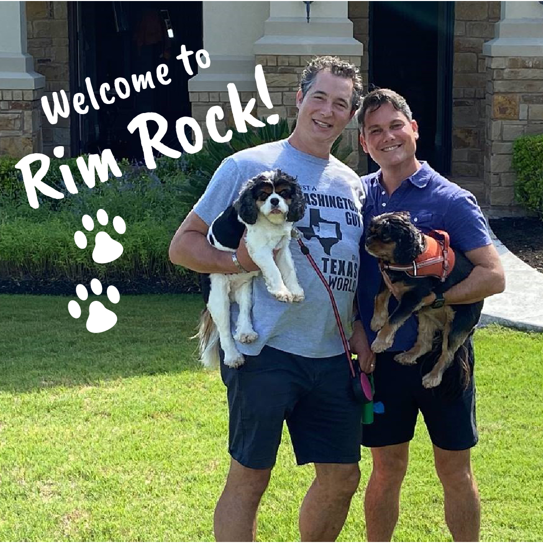 Two men holding dogs.