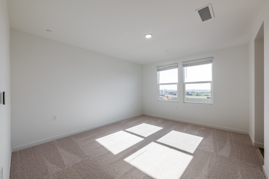 A room with a tile floor and windows.