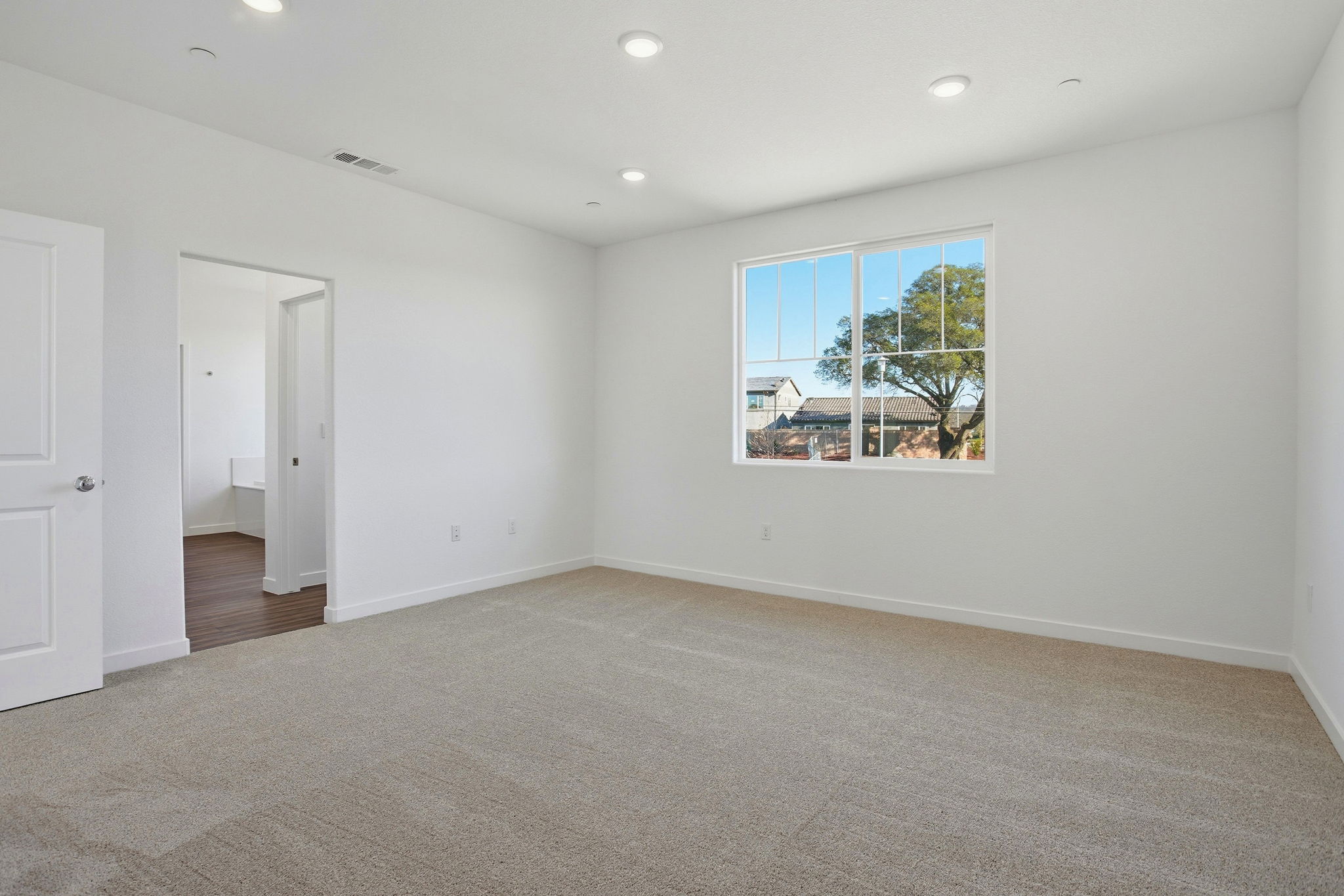 A room with a window and a door.