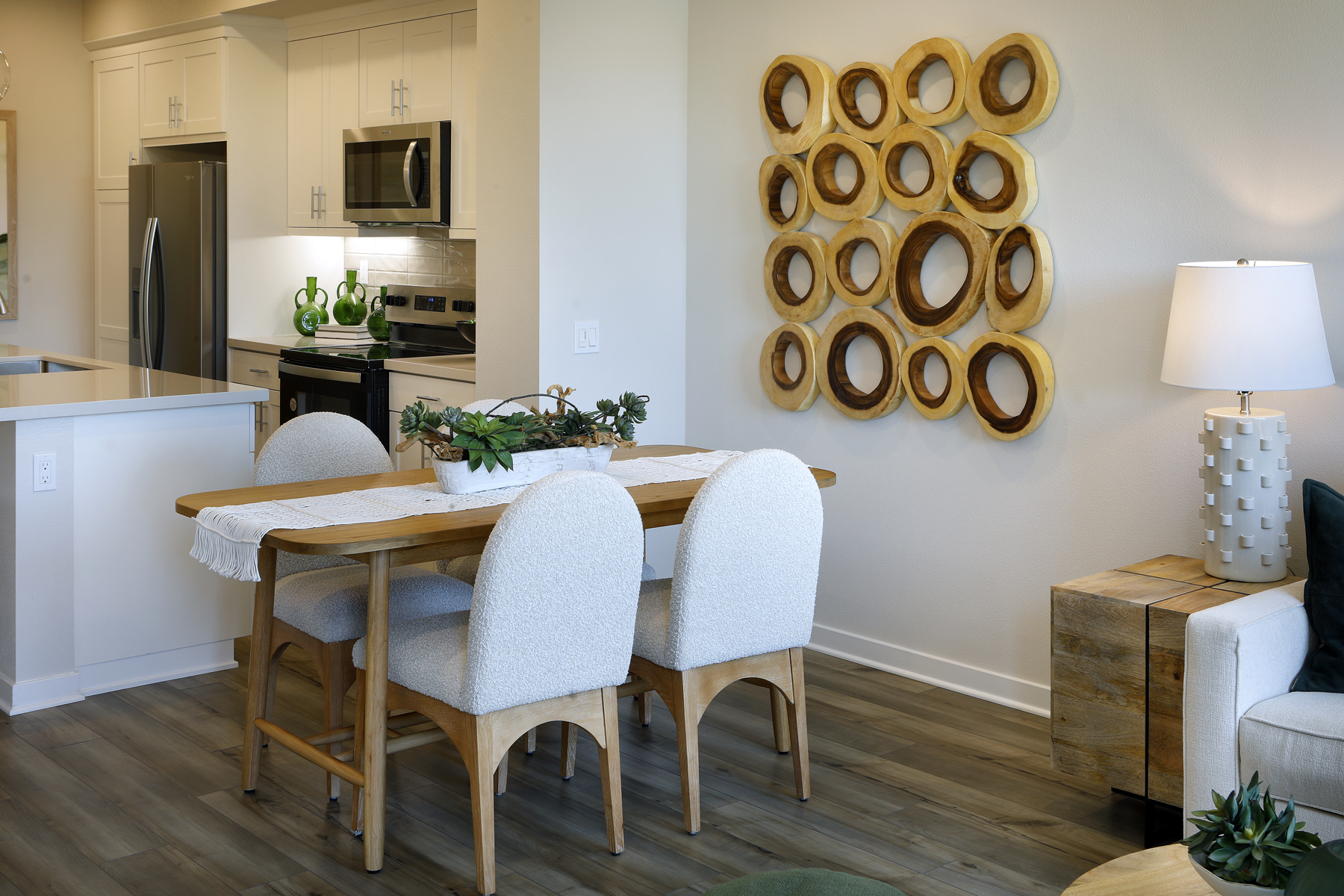 A dining room with a table and chairs.