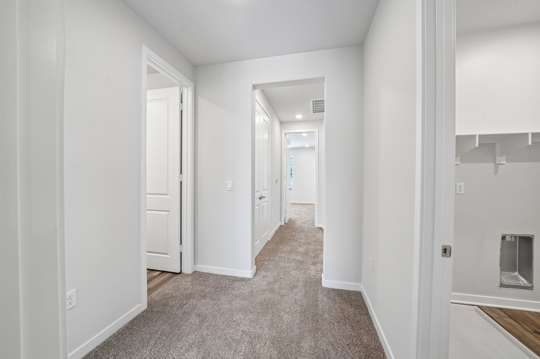 A hallway with white walls.