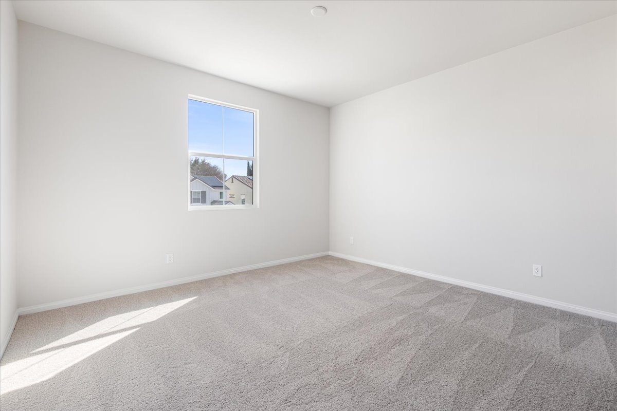 A room with a window and a carpet.