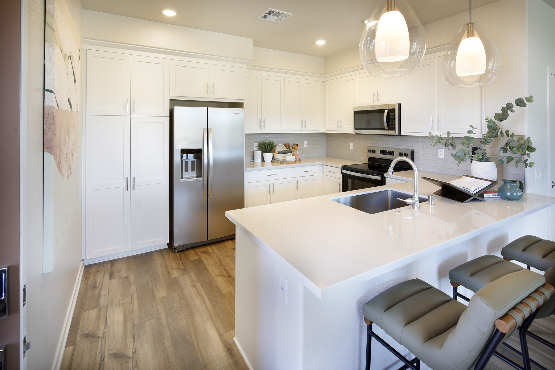 A kitchen with white cabinets.