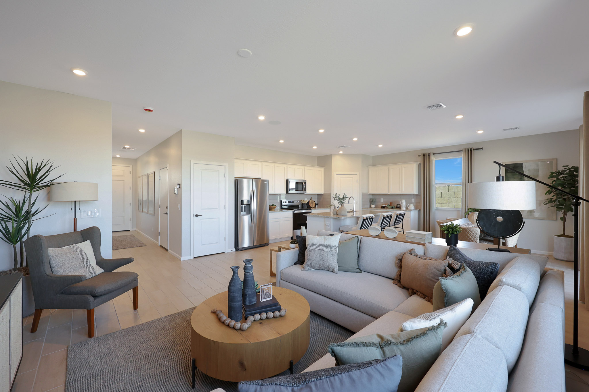 A living room with a large couch and a dining table.