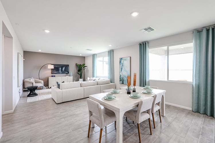 A living room with a table and chairs.