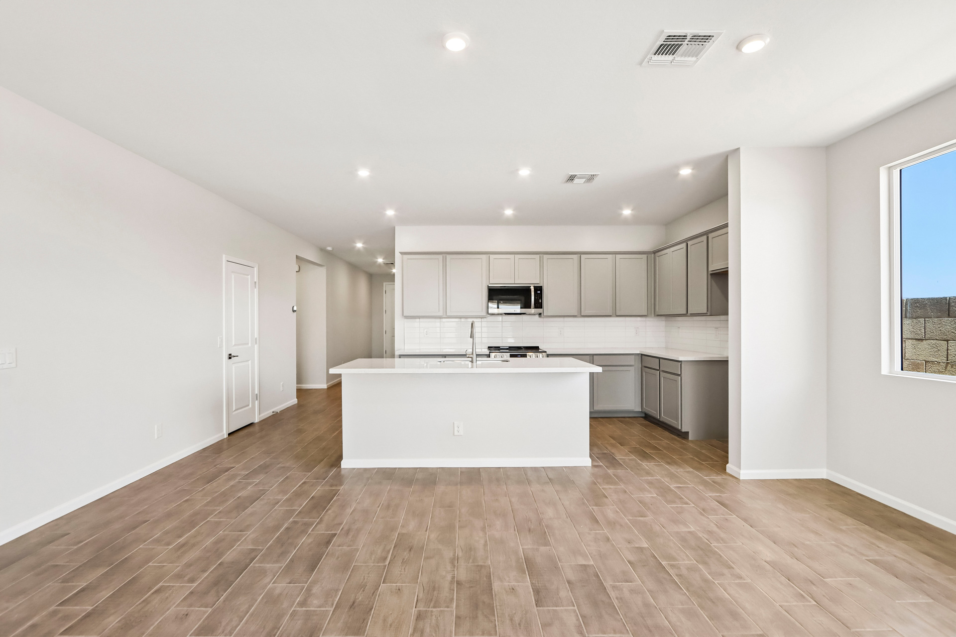 A kitchen with white cabinets.