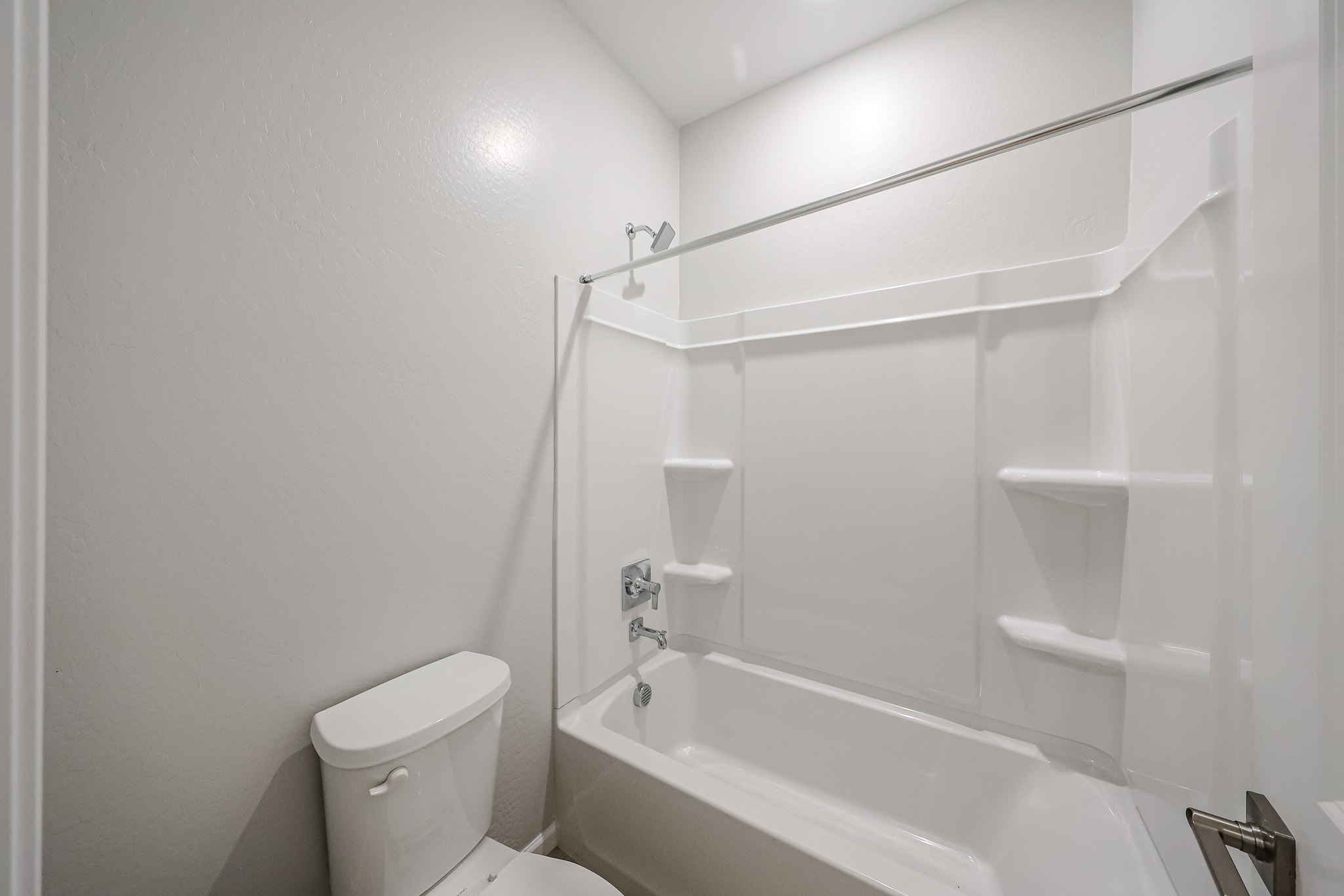 A bathroom with a tub toilet and sink.