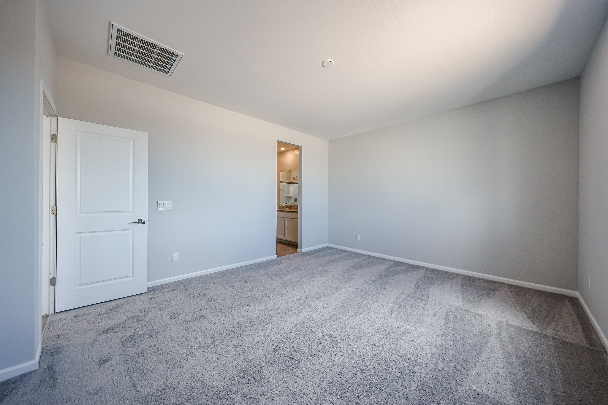 A hallway with white doors.