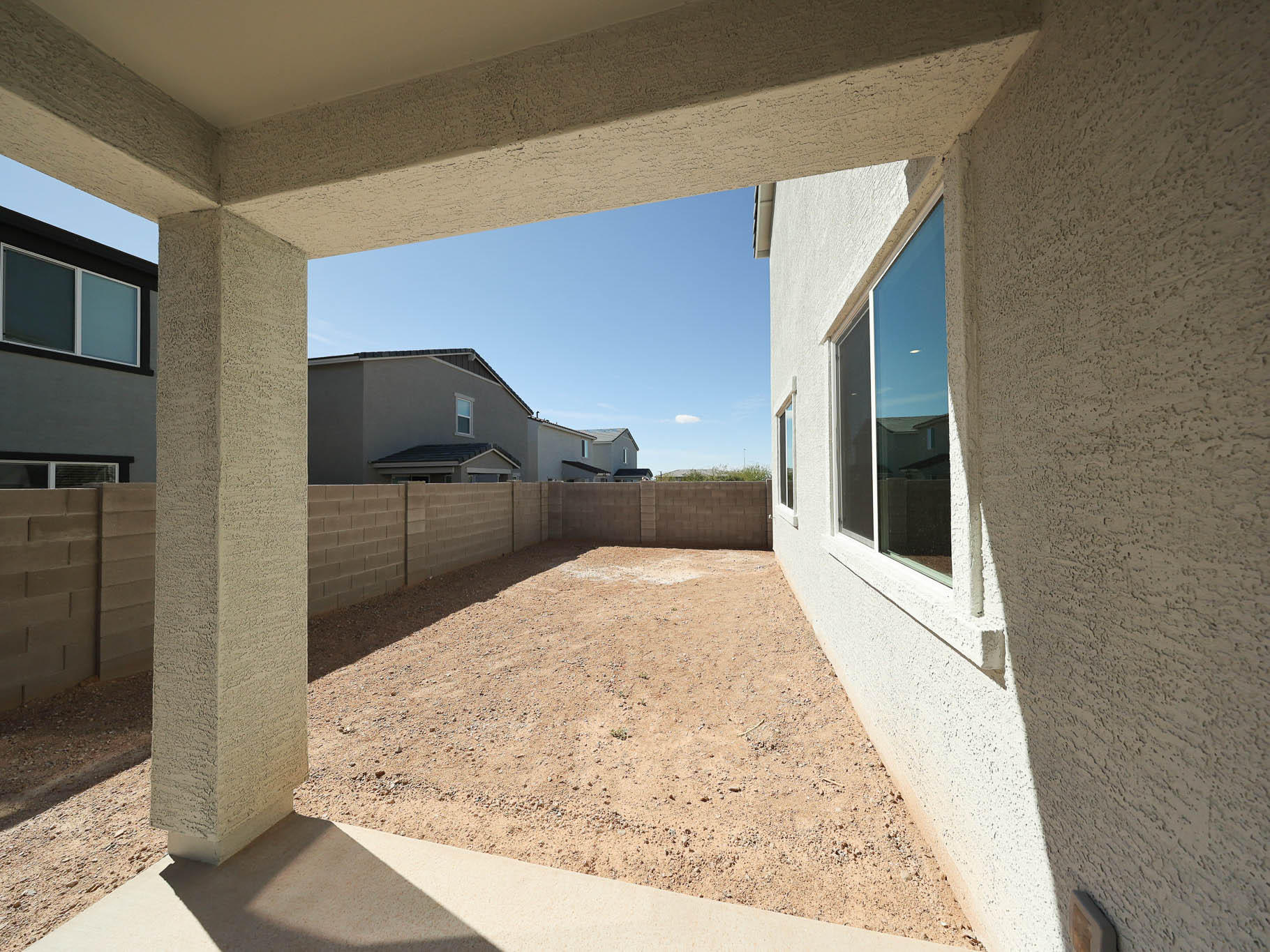 A building with a fence and a dirt path.