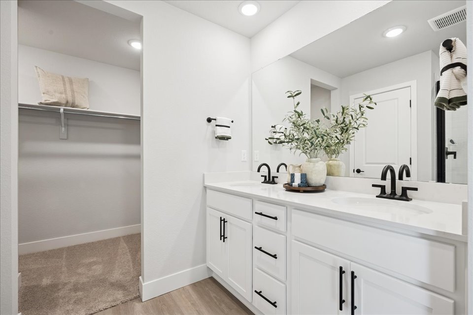 A bathroom with a sink and a shower.