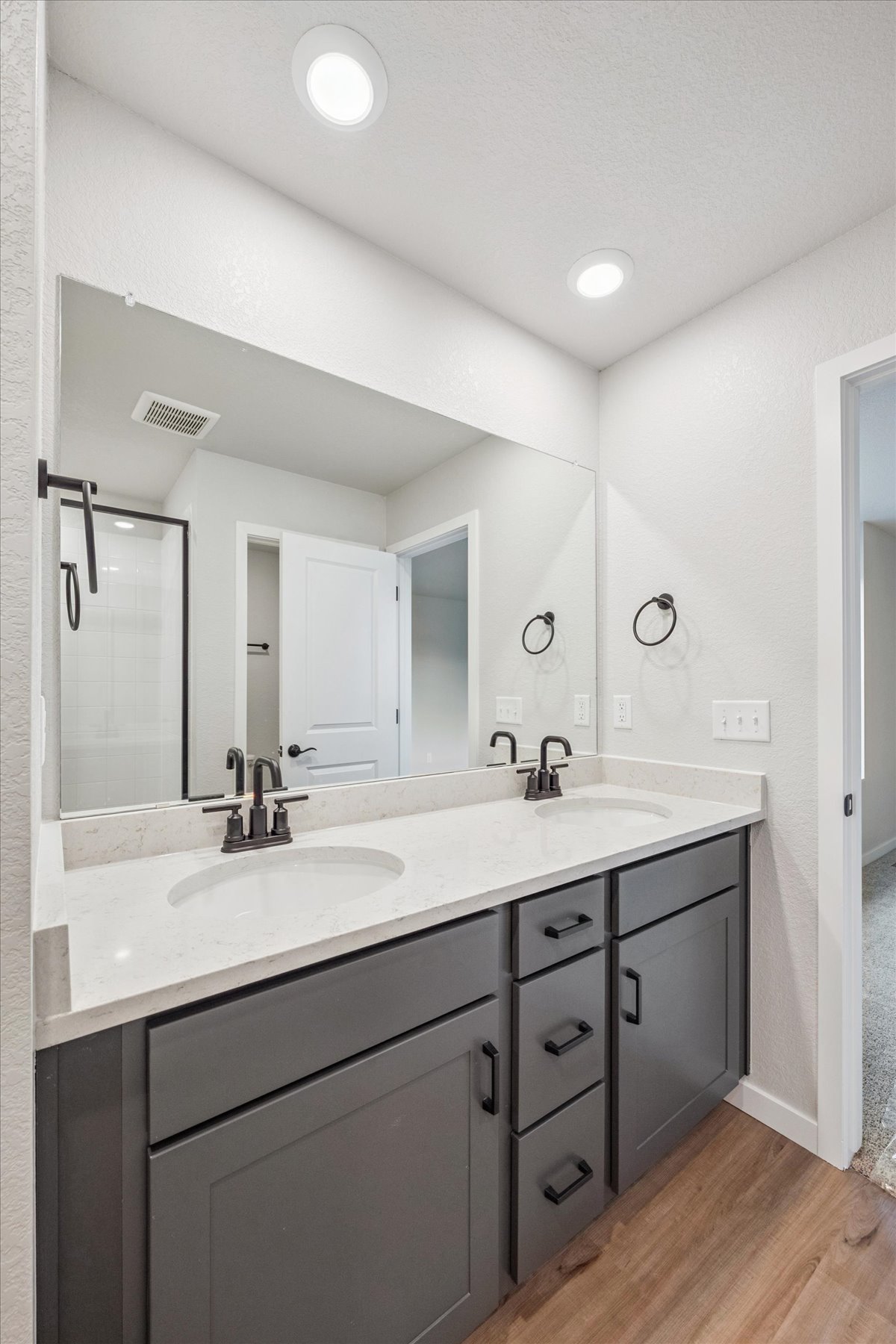 A bathroom with a large mirror.