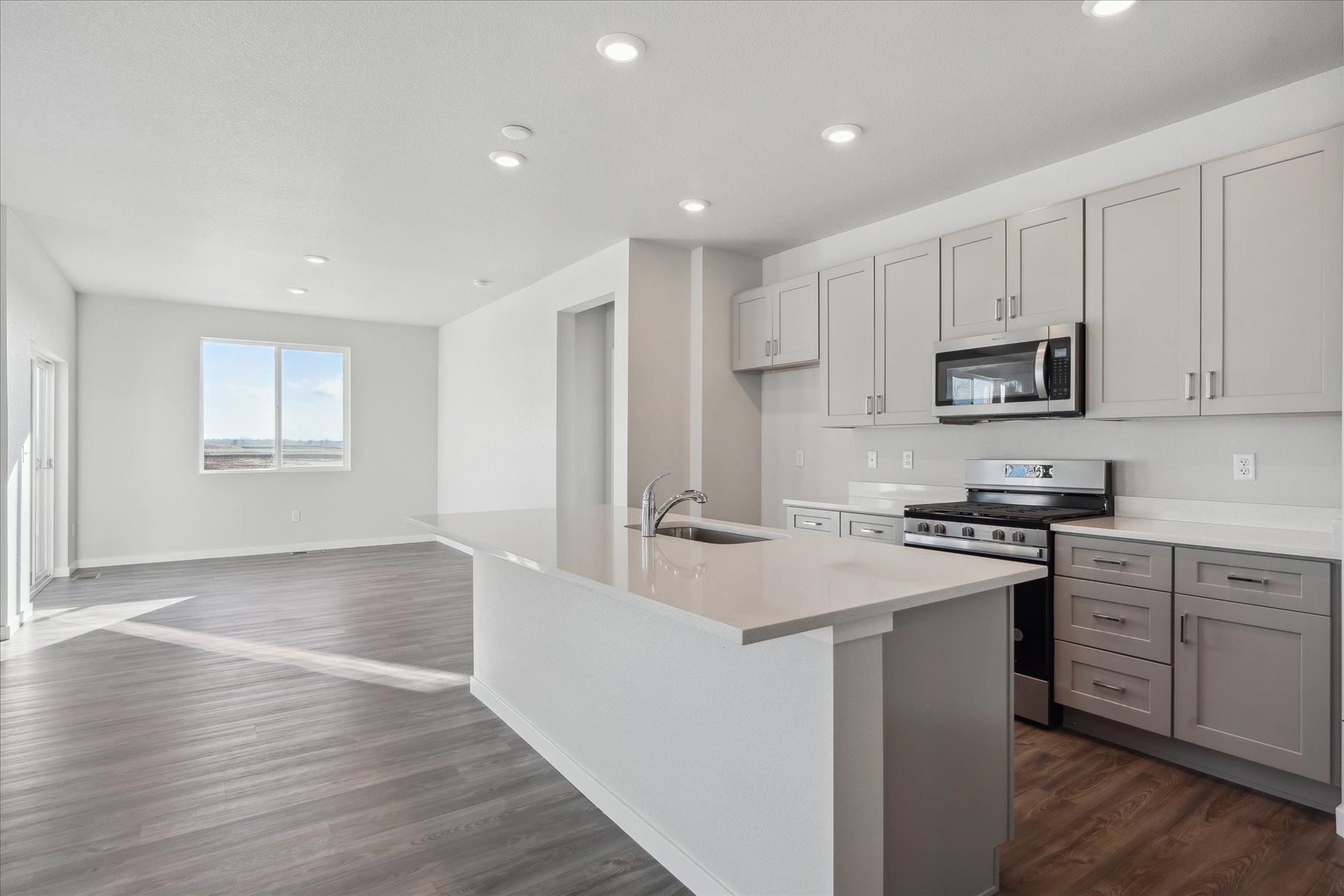 A kitchen with white cabinets.