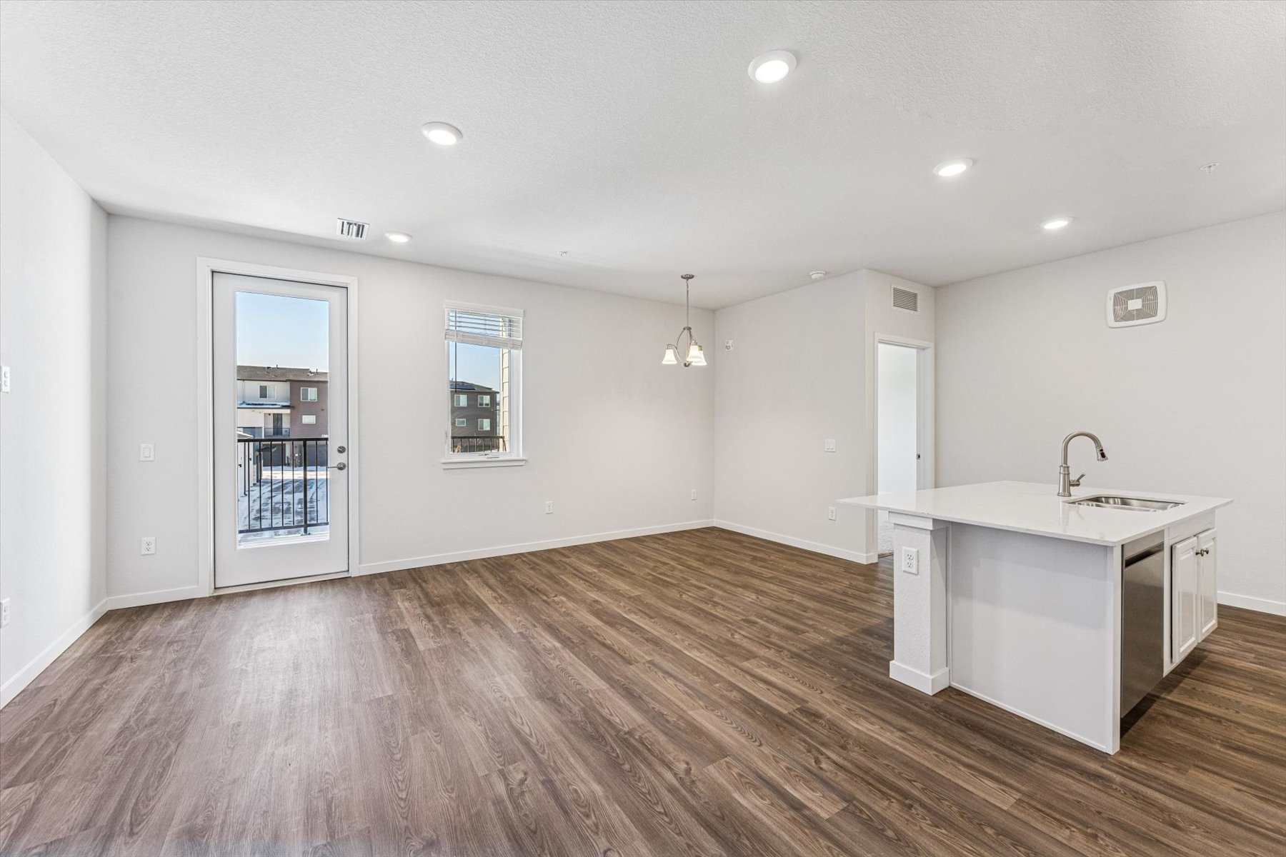A kitchen with white cabinets.
