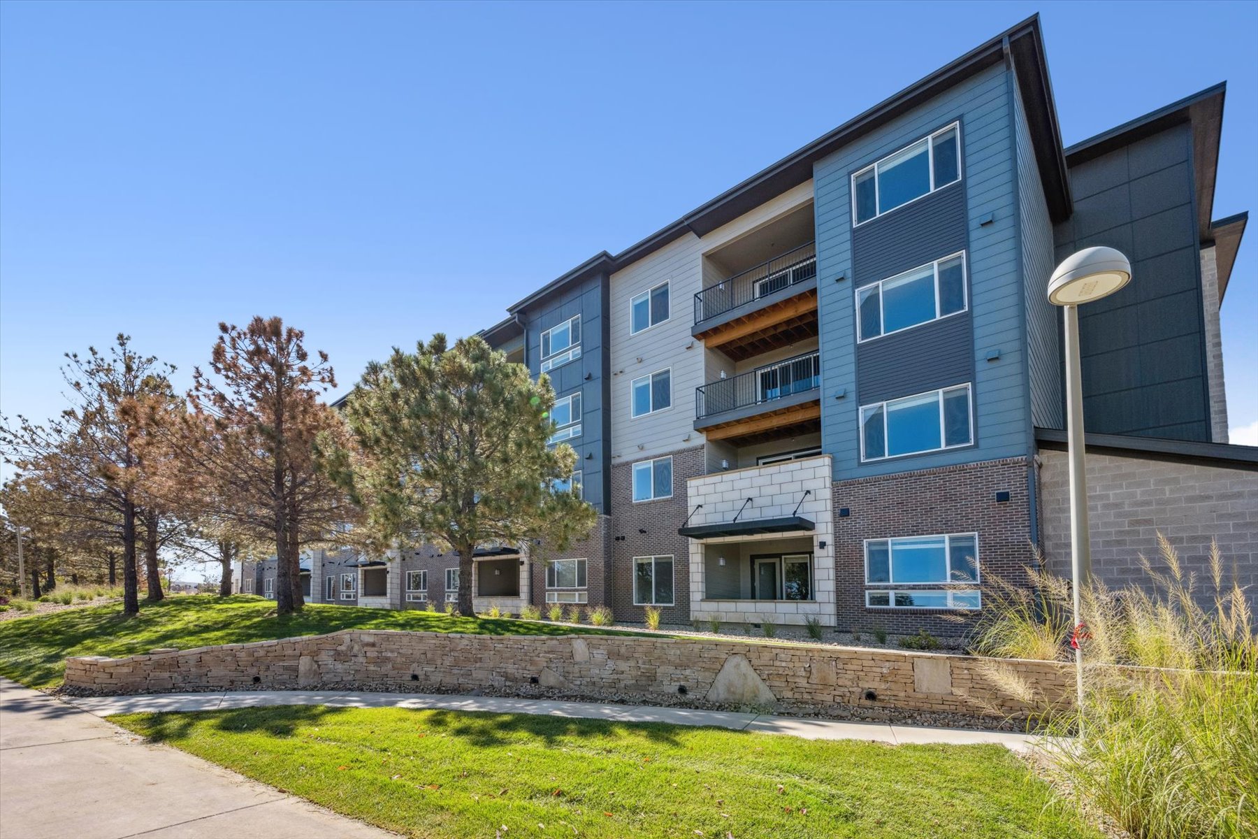 A building with a lawn and trees.