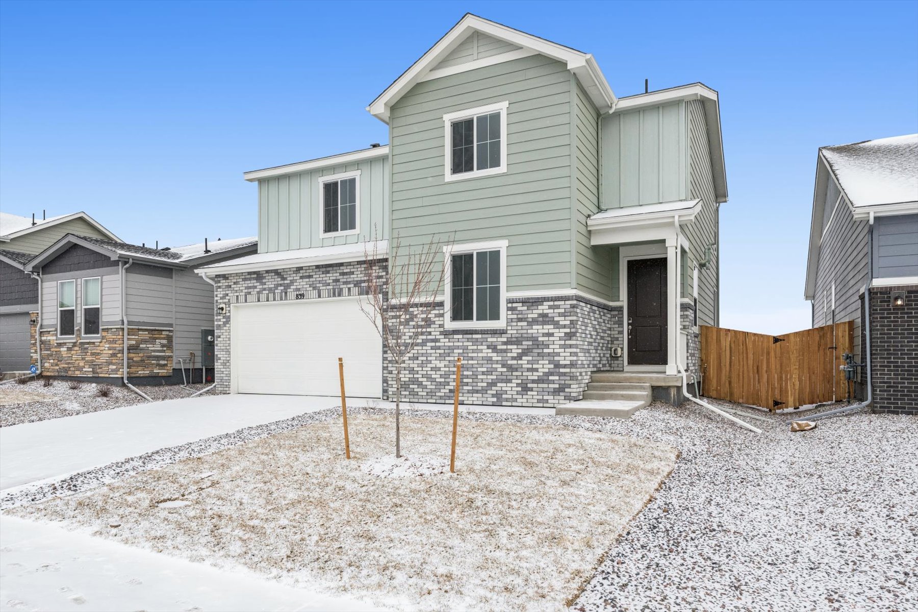A house with a fence and snow.