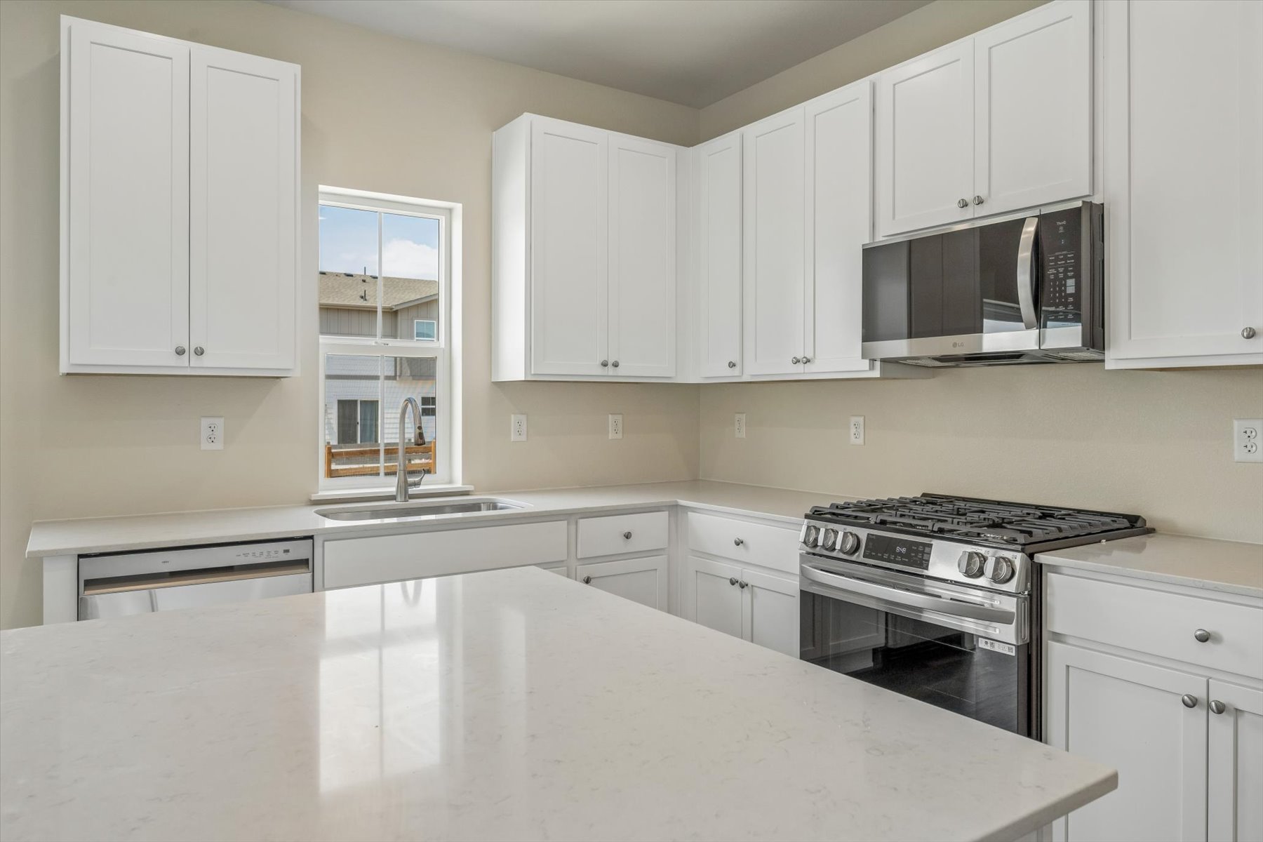 A kitchen with white cabinets.