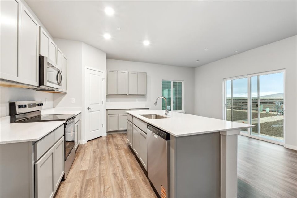 A kitchen with white cabinets.