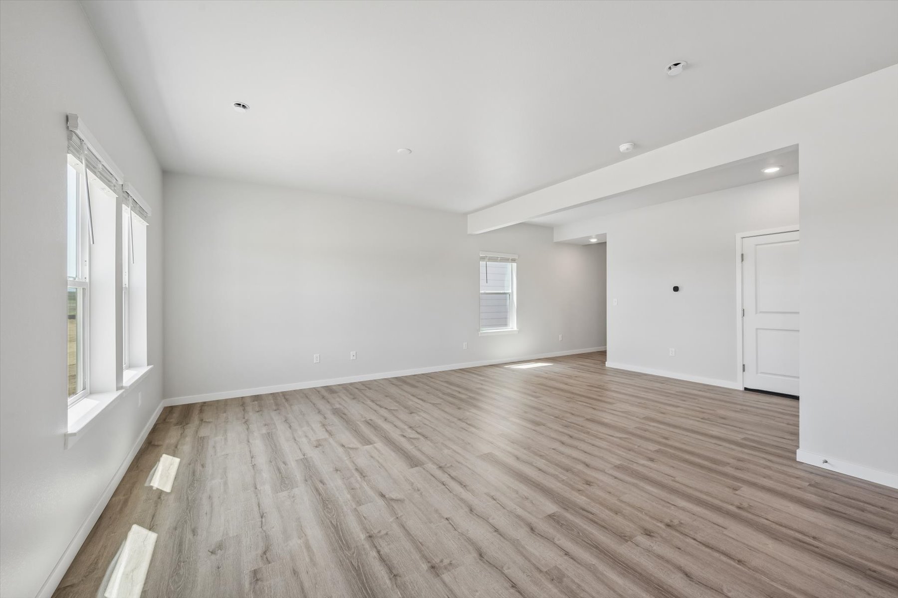 A room with a wood floor and white walls.