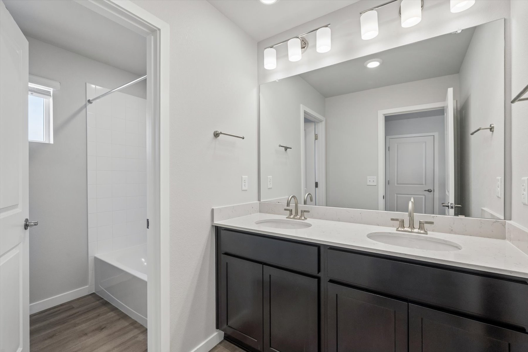 A bathroom with a sink and a shower unit.
