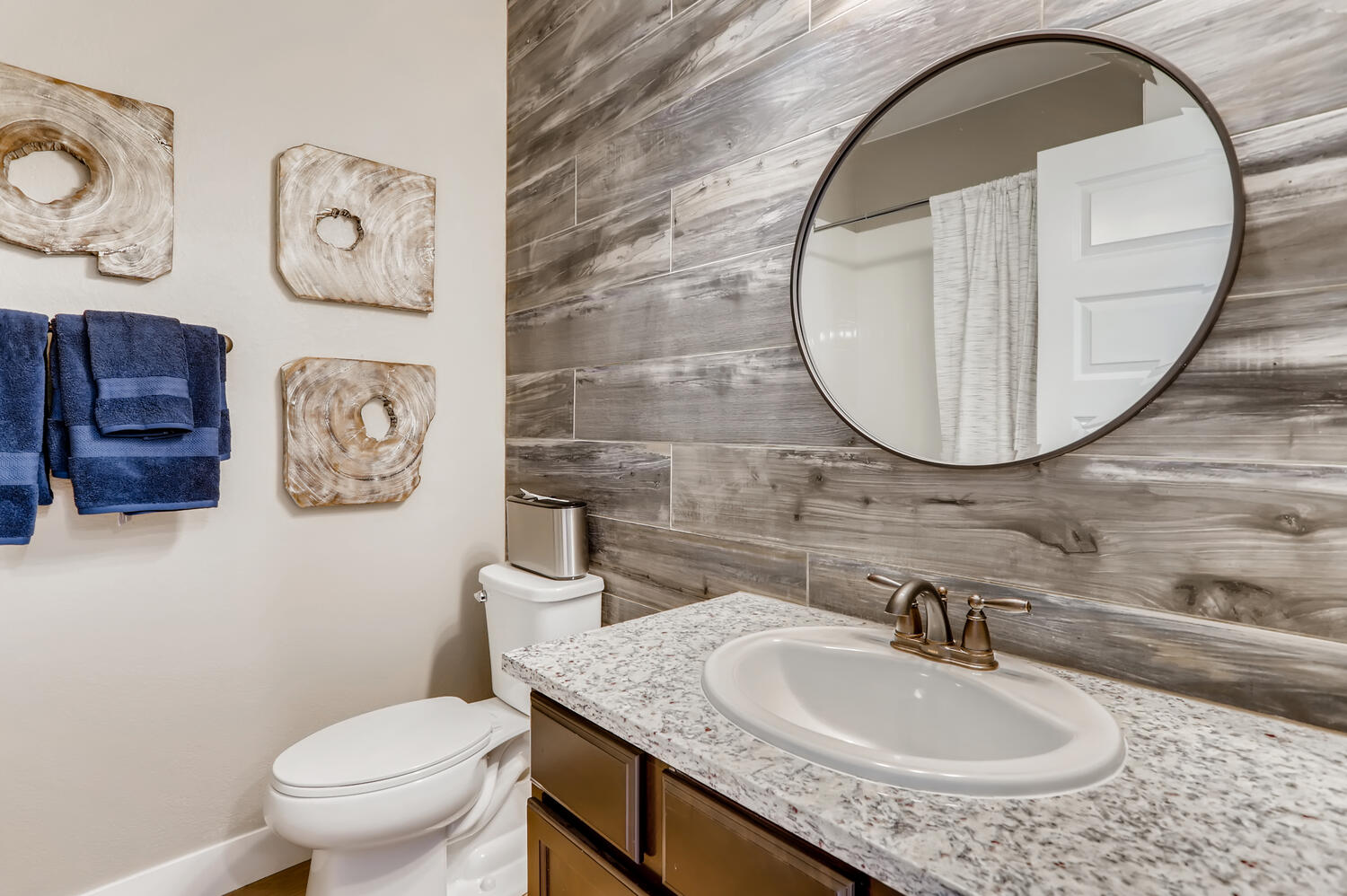 A bathroom with a large mirror.