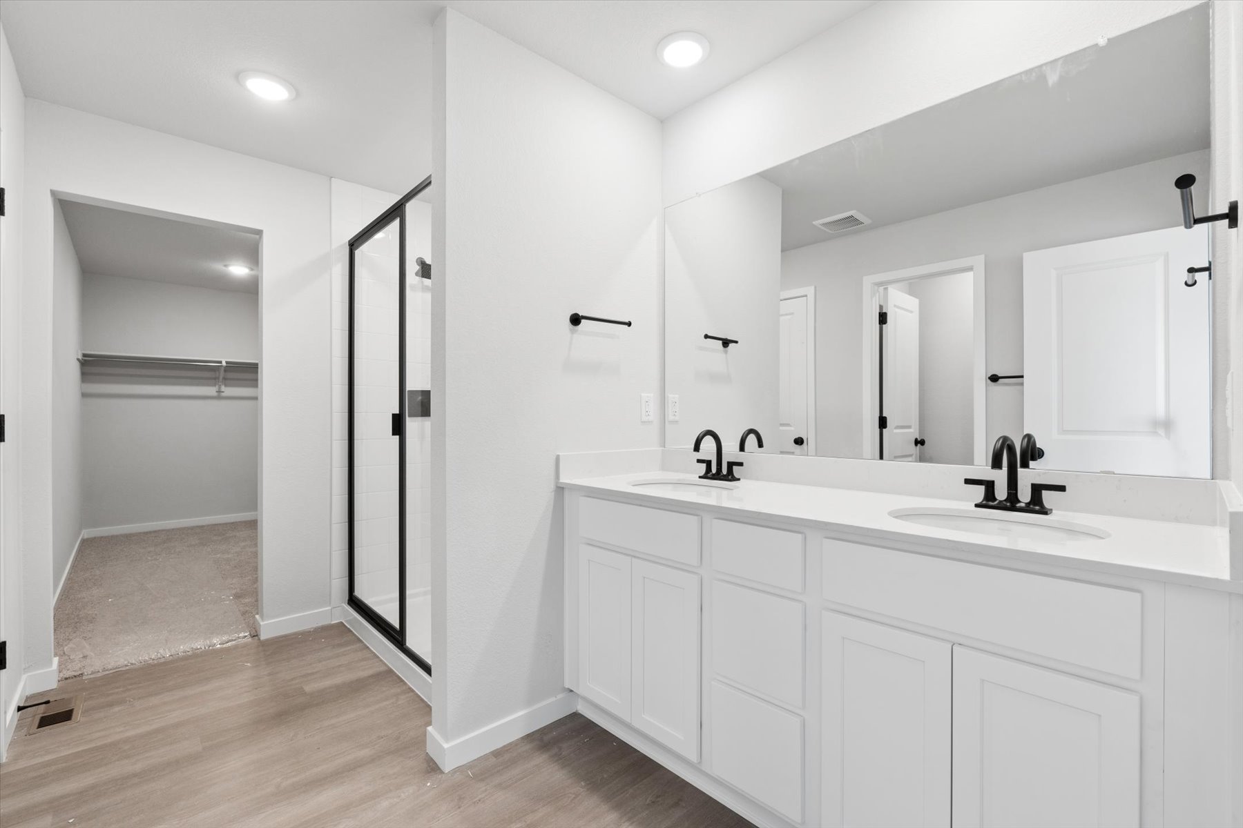 A bathroom with white cabinets.