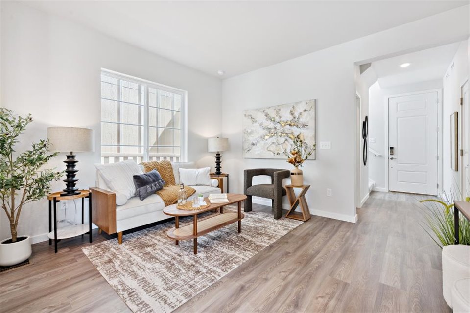 A living room with a rug and a coffee table.
