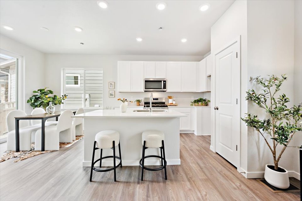 A kitchen with white cabinets.