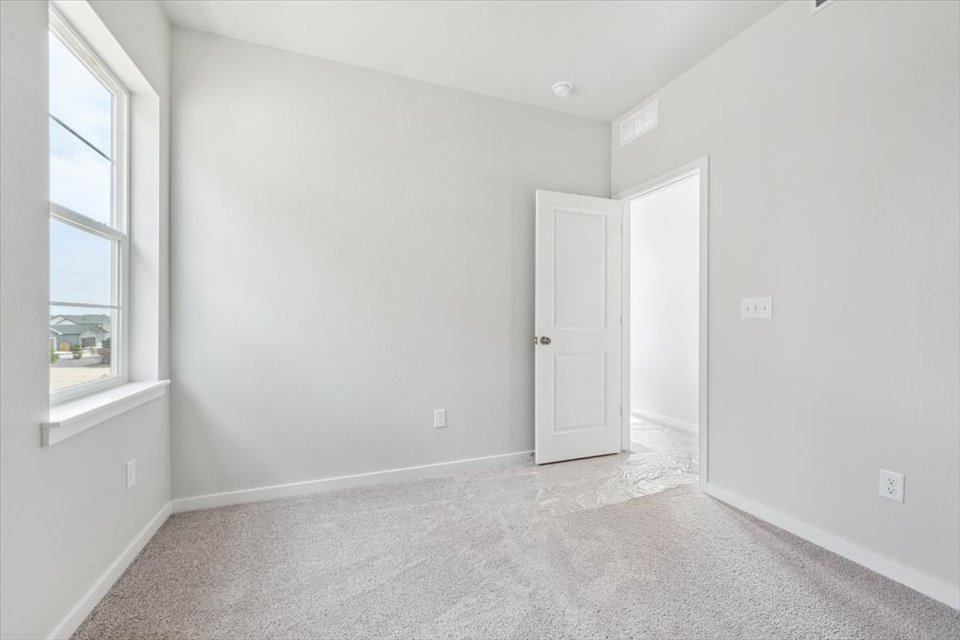 A room with white walls and a window.