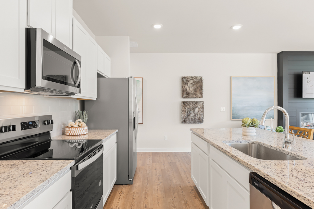 A kitchen with white cabinets.