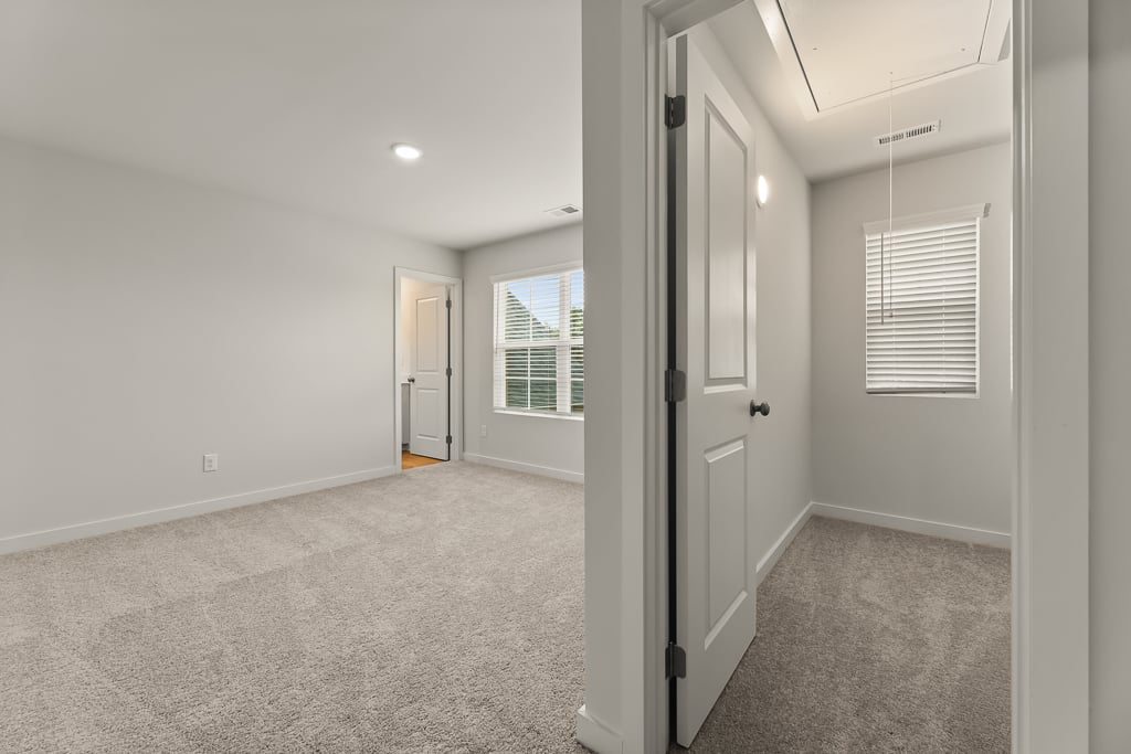 A hallway with white doors.