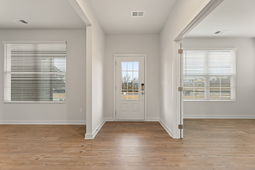 A room with a wood floor and white walls.