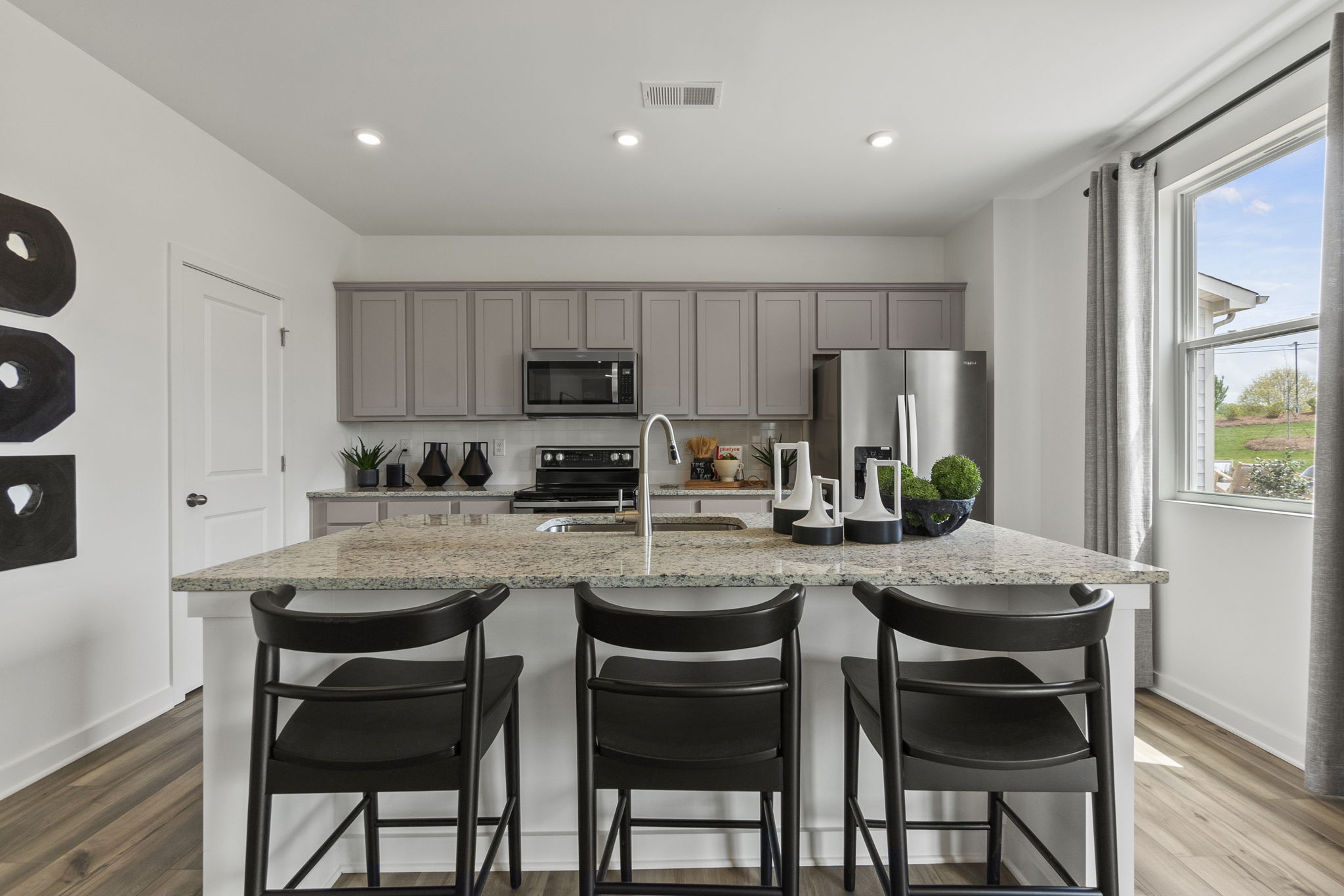A kitchen with a marble island.