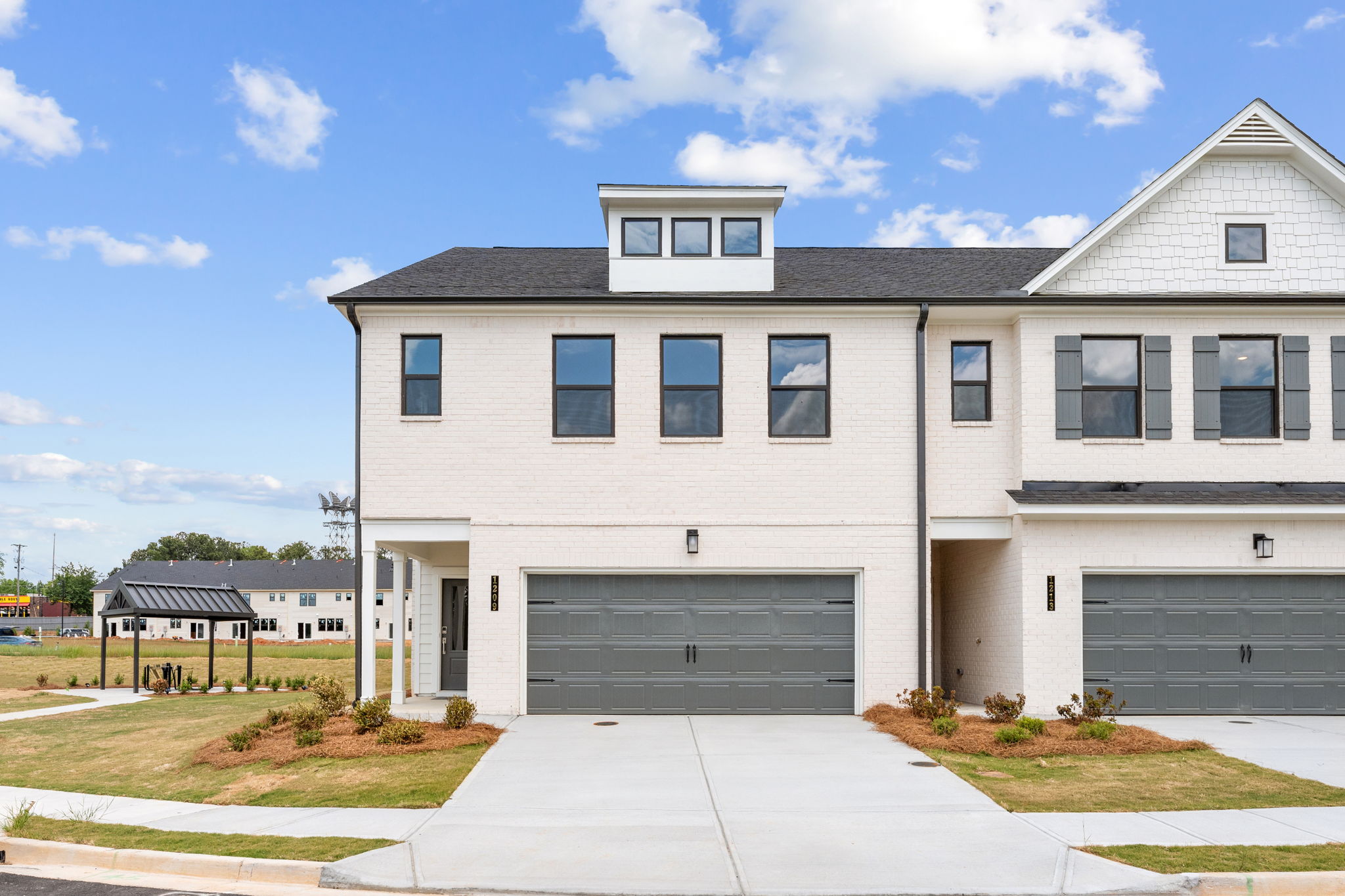 A white building with a garage.
