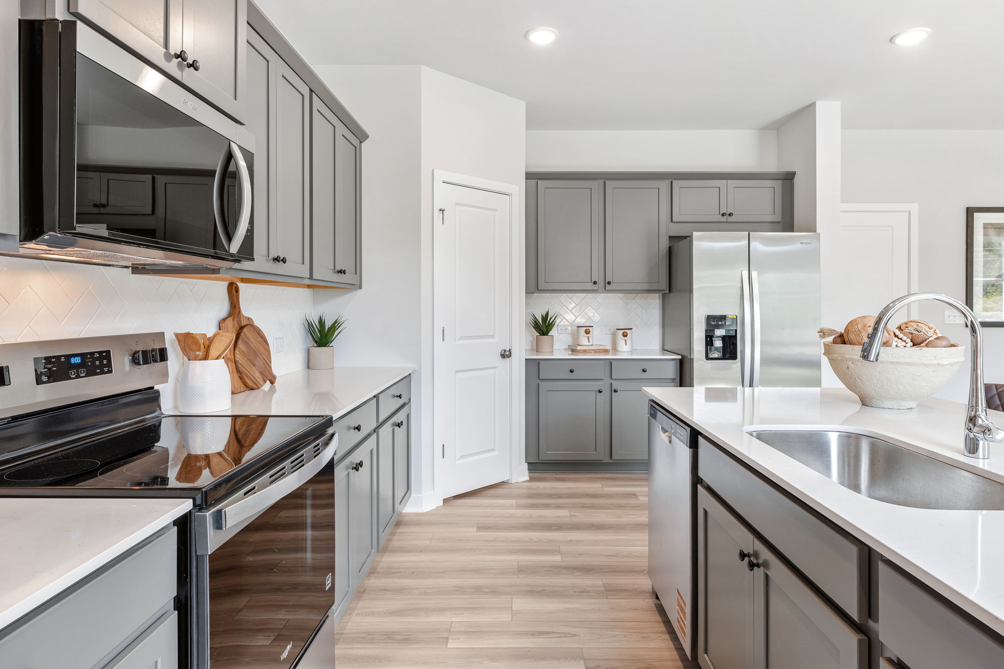A kitchen with white cabinets.