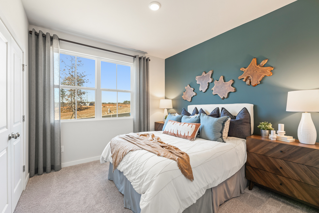 A bedroom with a bed and a window.