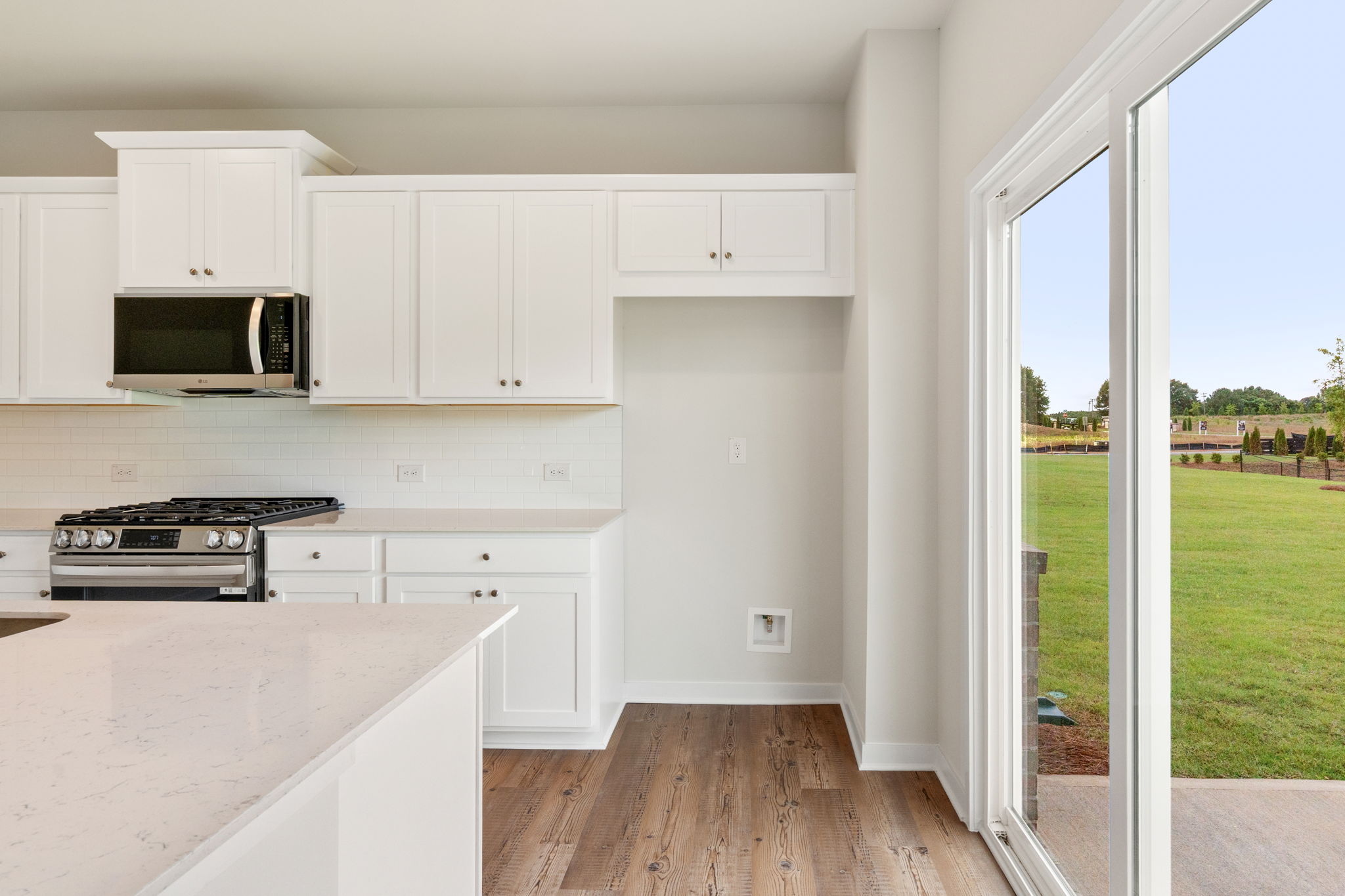 A kitchen with white cabinets.