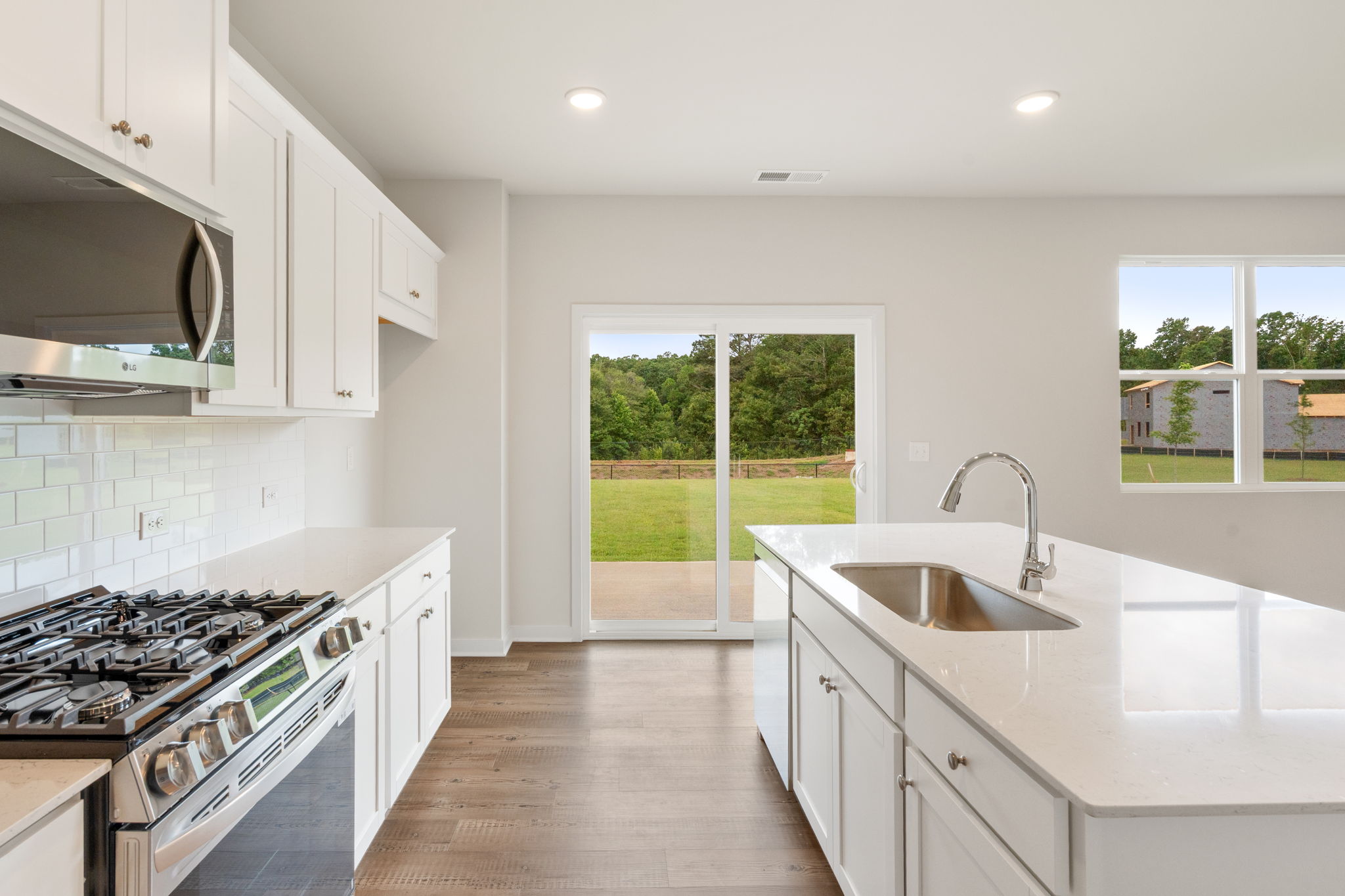 A kitchen with white cabinets.