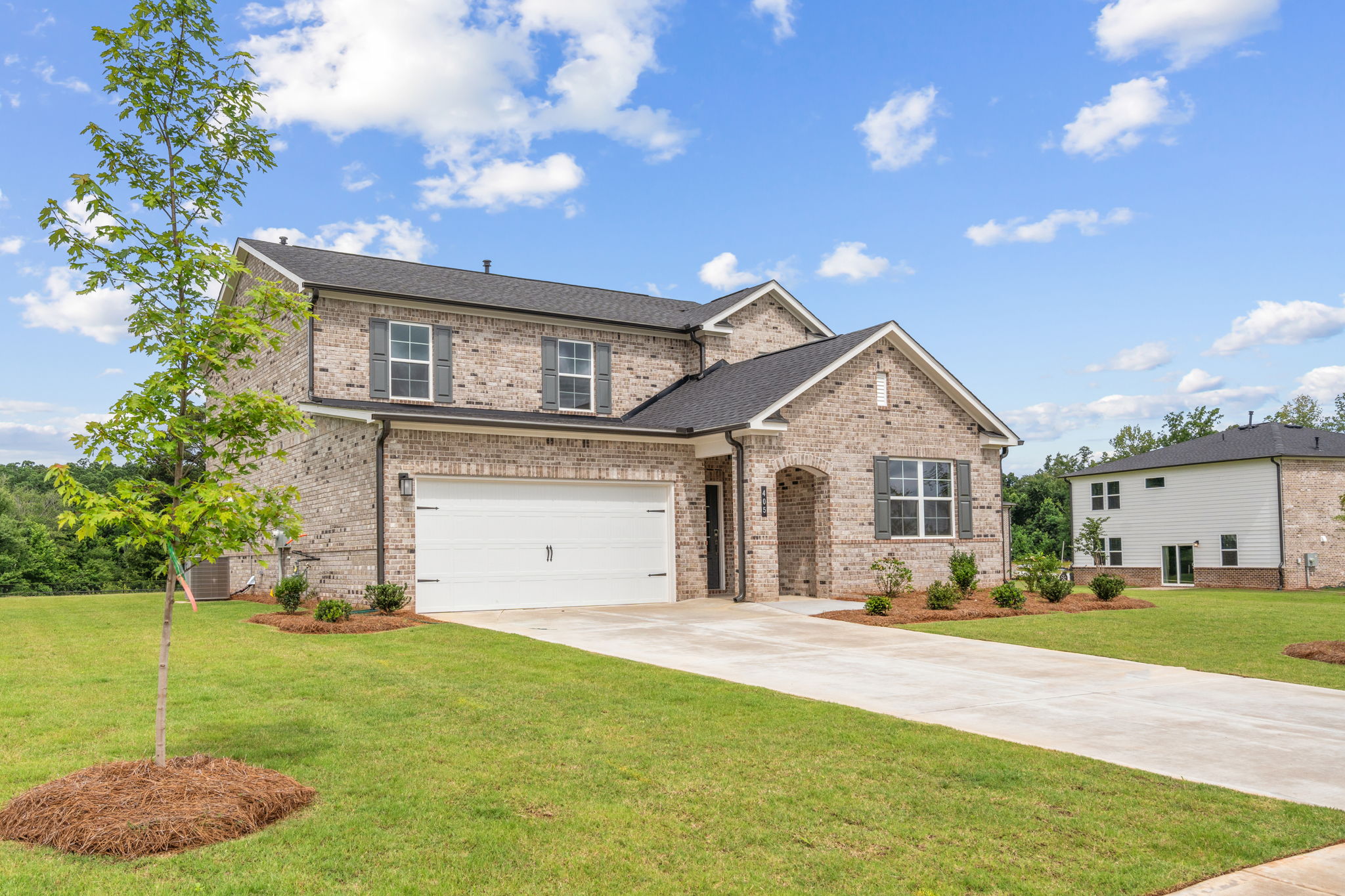 A large brick house with a driveway.