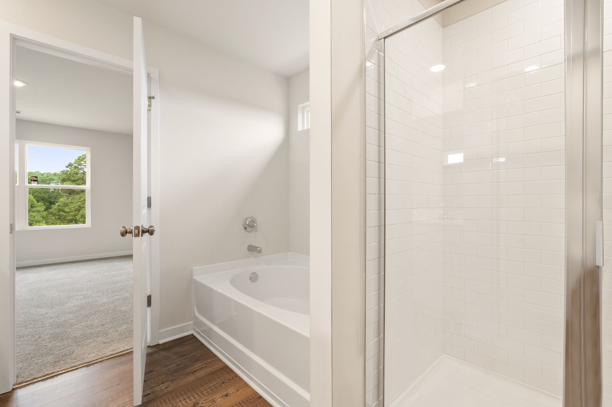 A bathroom with a tub and shower.