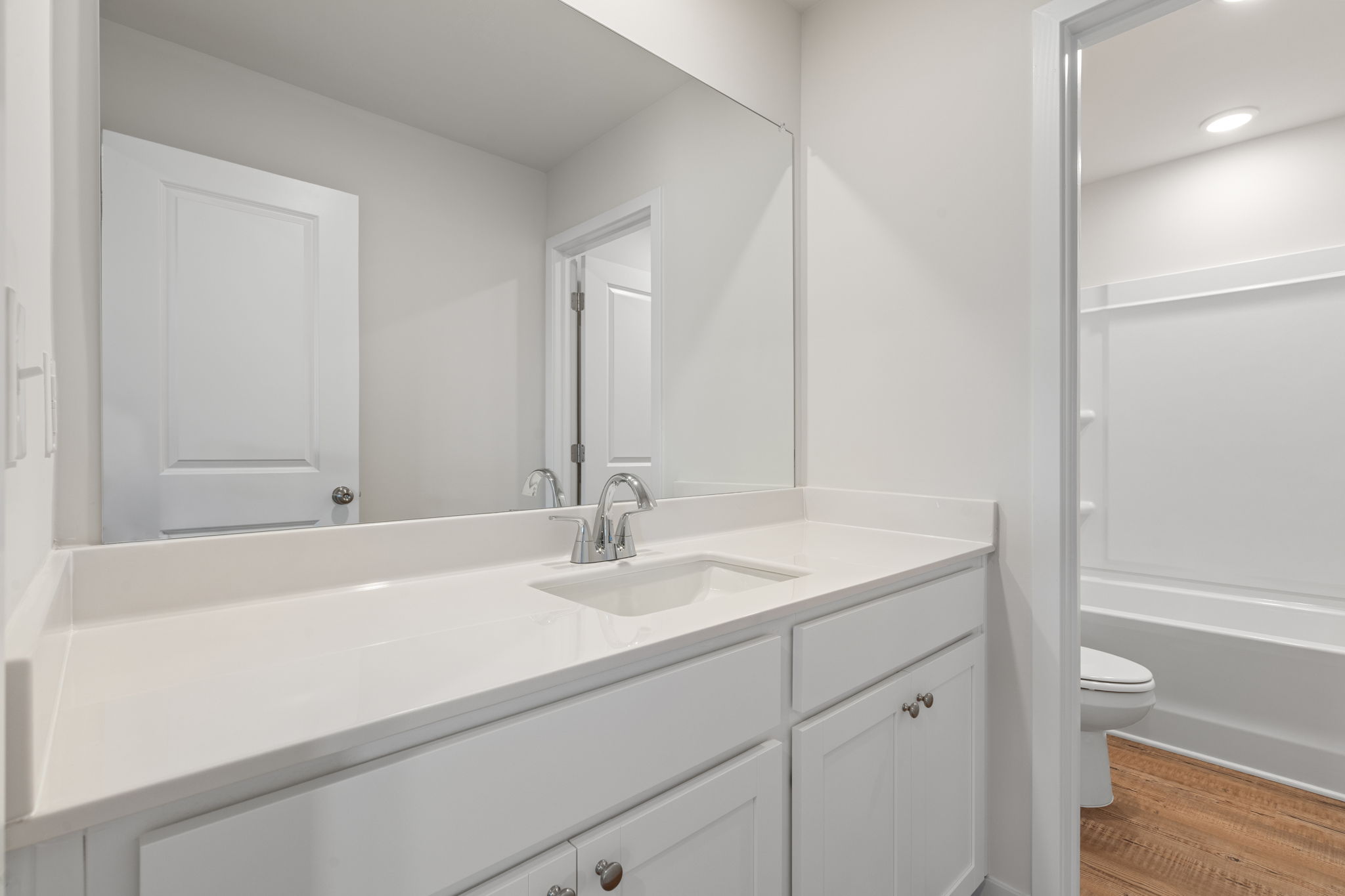 A bathroom with a sink and a toilet.