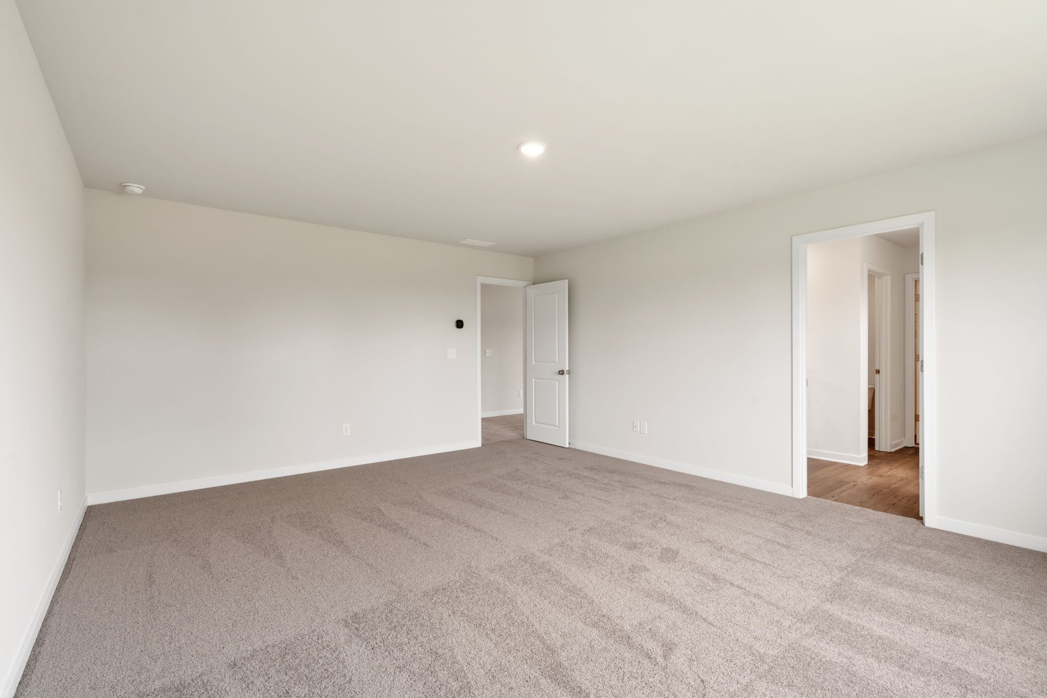 A hallway with white walls.
