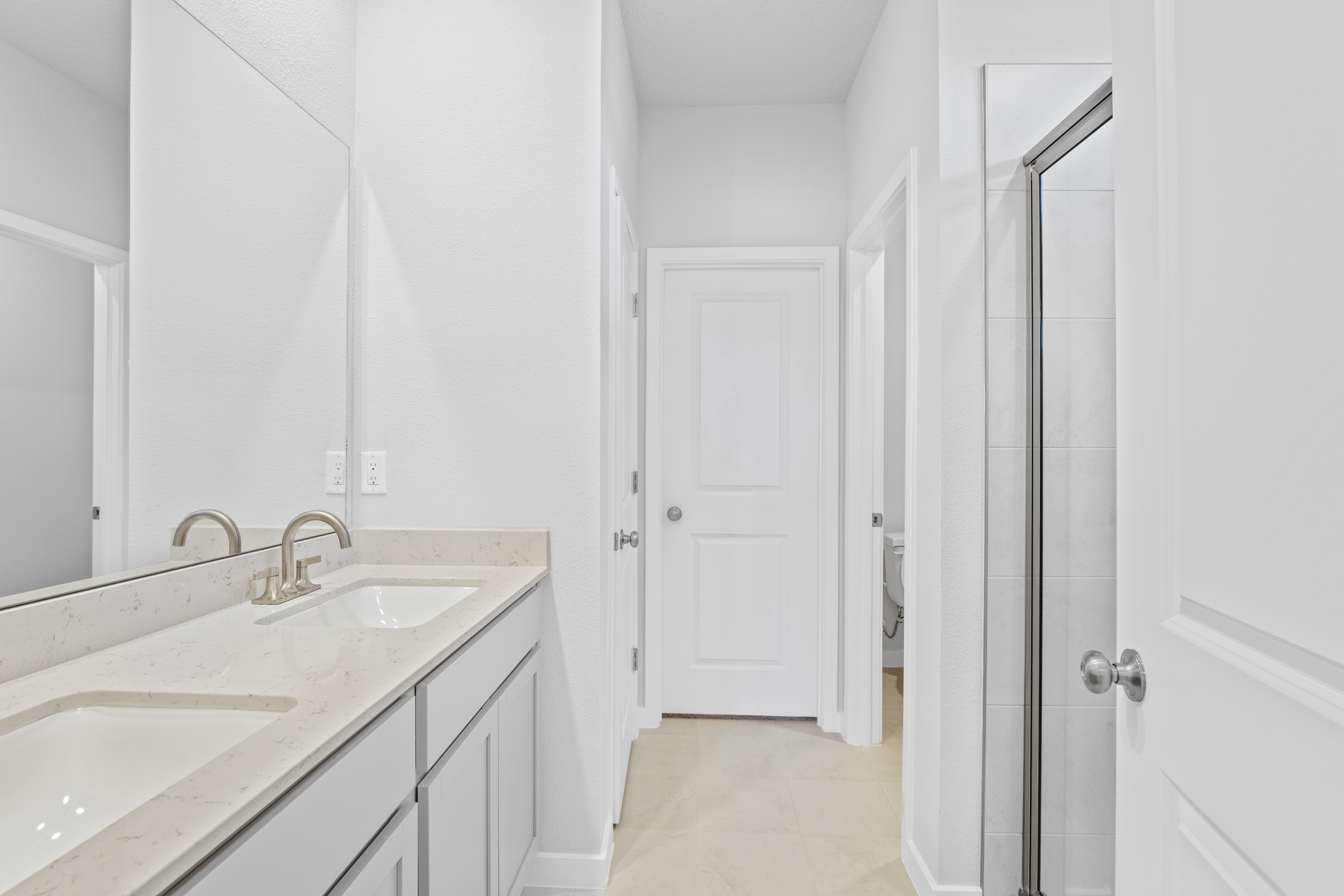 Lot 145 Primary Bath with Walk-In Shower and Dual Vanities at Camden Woods in Kingsland