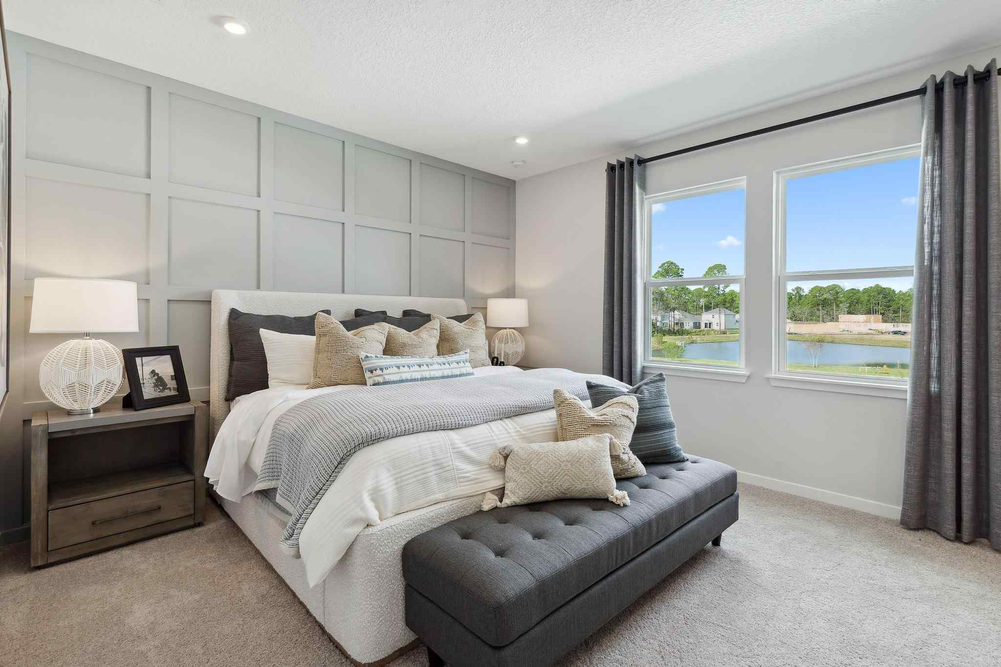 A bedroom with a large window.