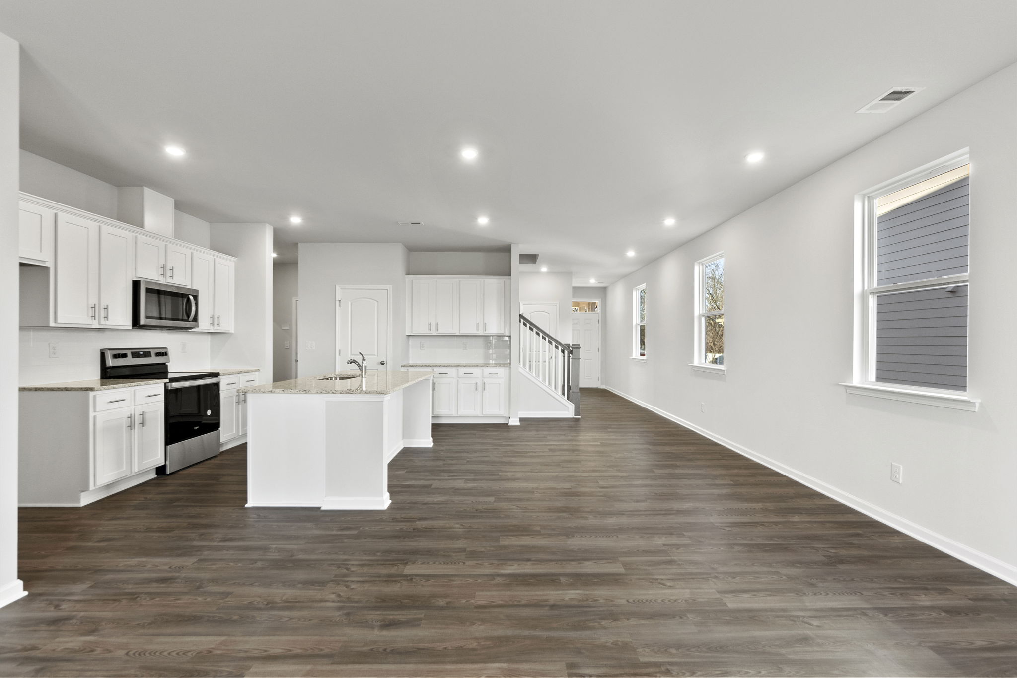 A large kitchen with white cabinets.