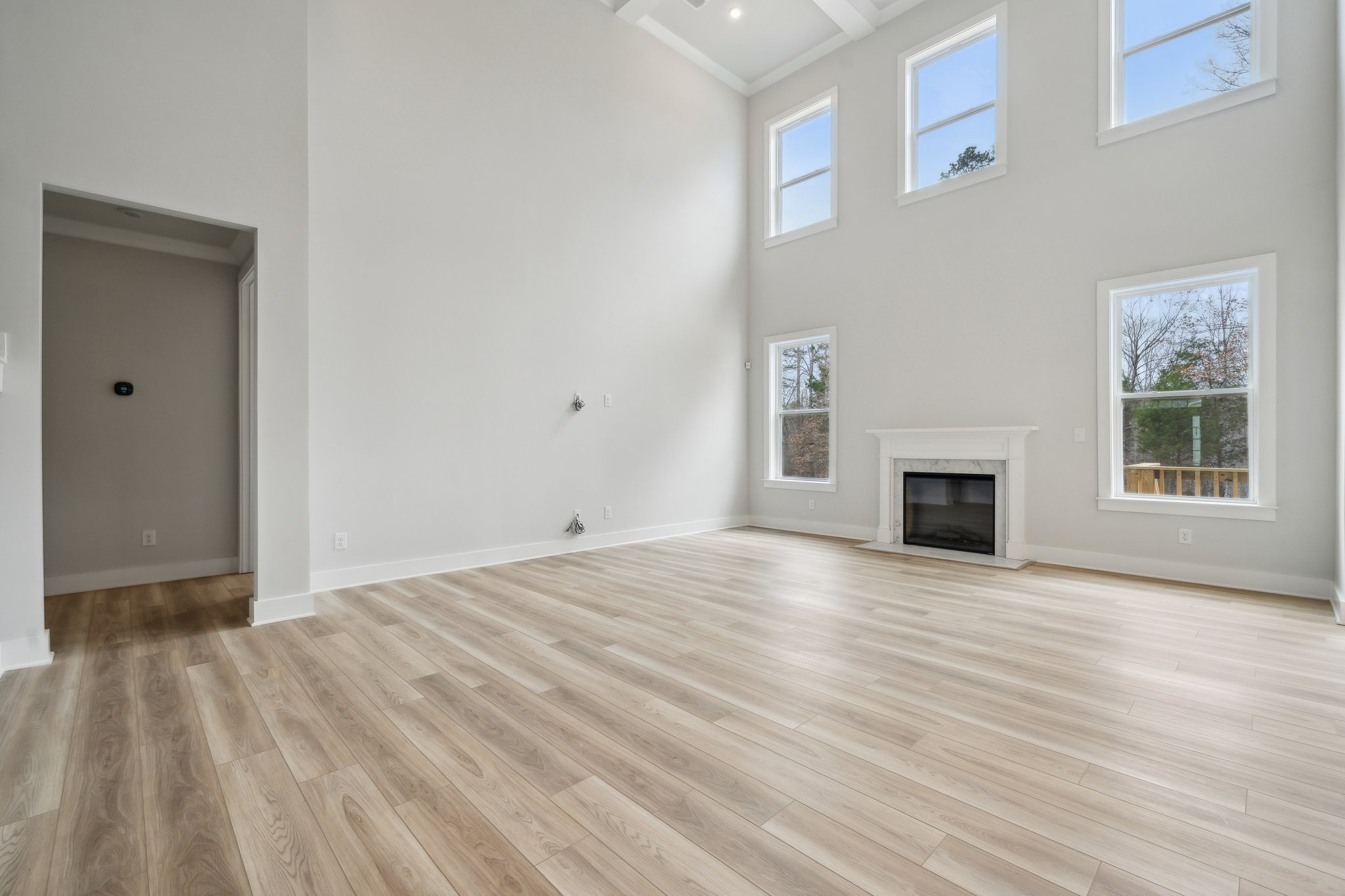 A room with a fireplace and a wood floor.