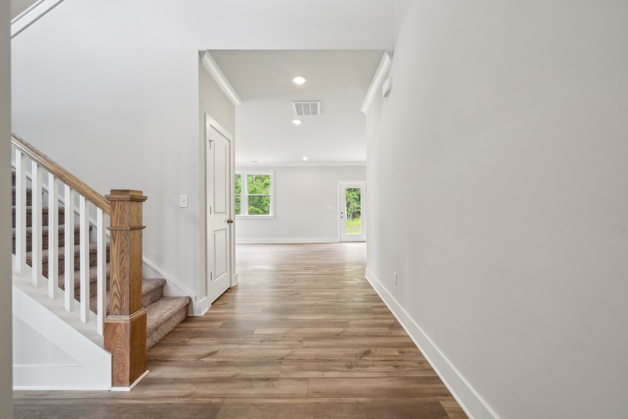 A hallway with a wood floor.
