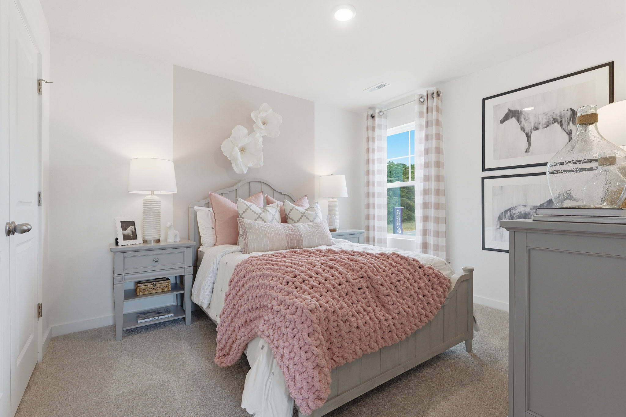A bedroom with a bed and a dresser.