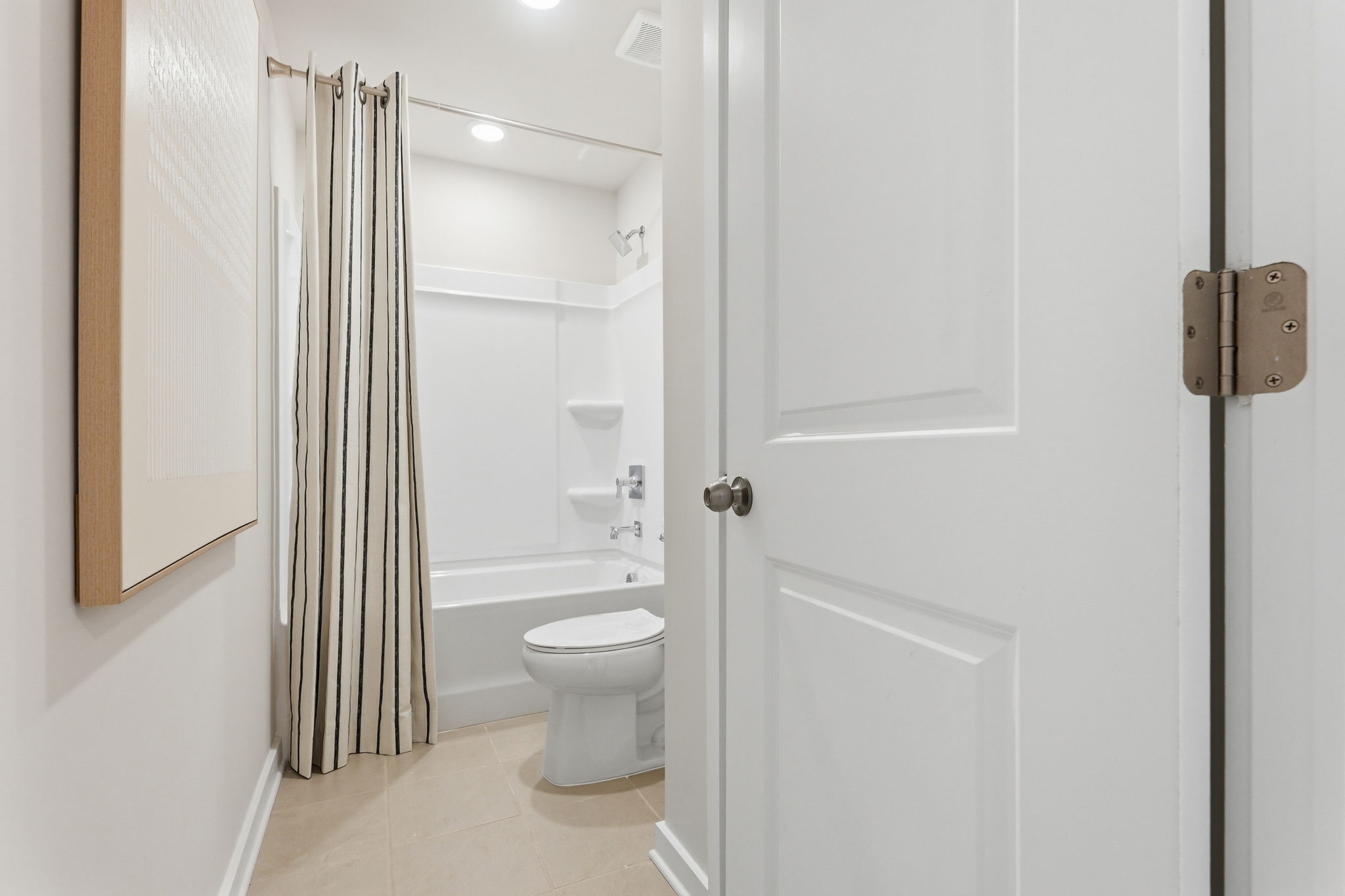 A bathroom with a toilet and shower.