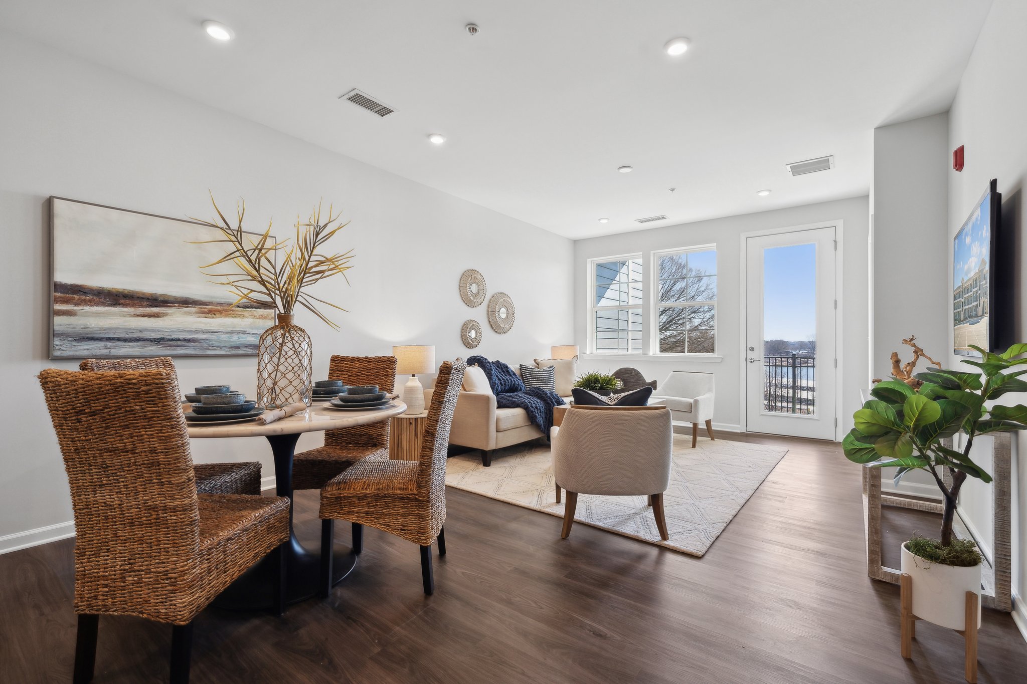 A dining room with a large table and chairs.