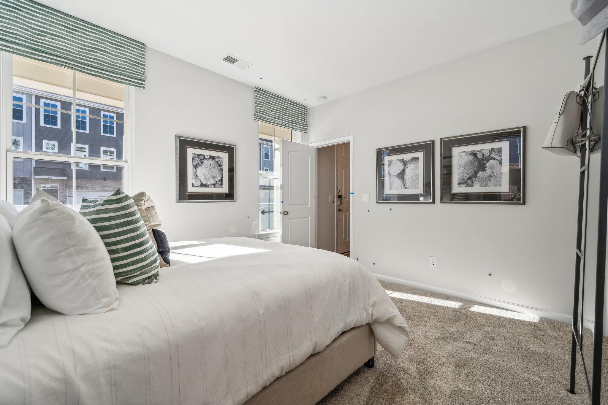 A bedroom with a bed and a lamp.